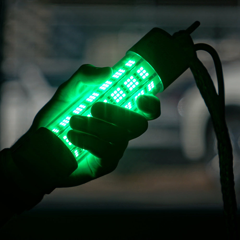 Hand holding Glowave light against a blurry background